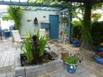 The Boathouse opens out onto the Courtyard with a
                  shady pergola and lovely water fountain.